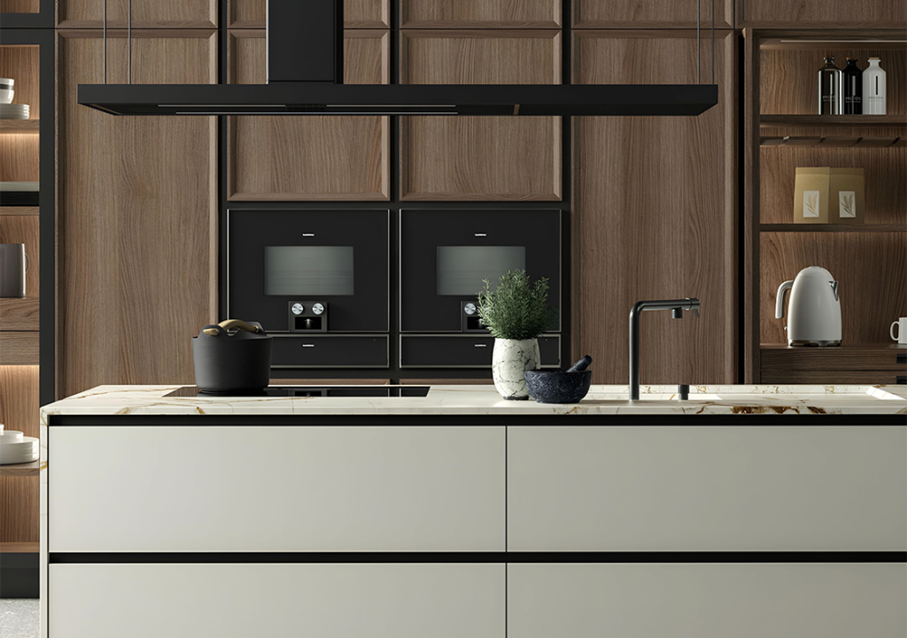 Luxury kitchen with wooden cabinetry, marble countertop, double oven, and black range hood. The island features a sink, potted plant, and a stone mortar and pestle set. Perfect for anyone considering a luxury kitchen renovation.