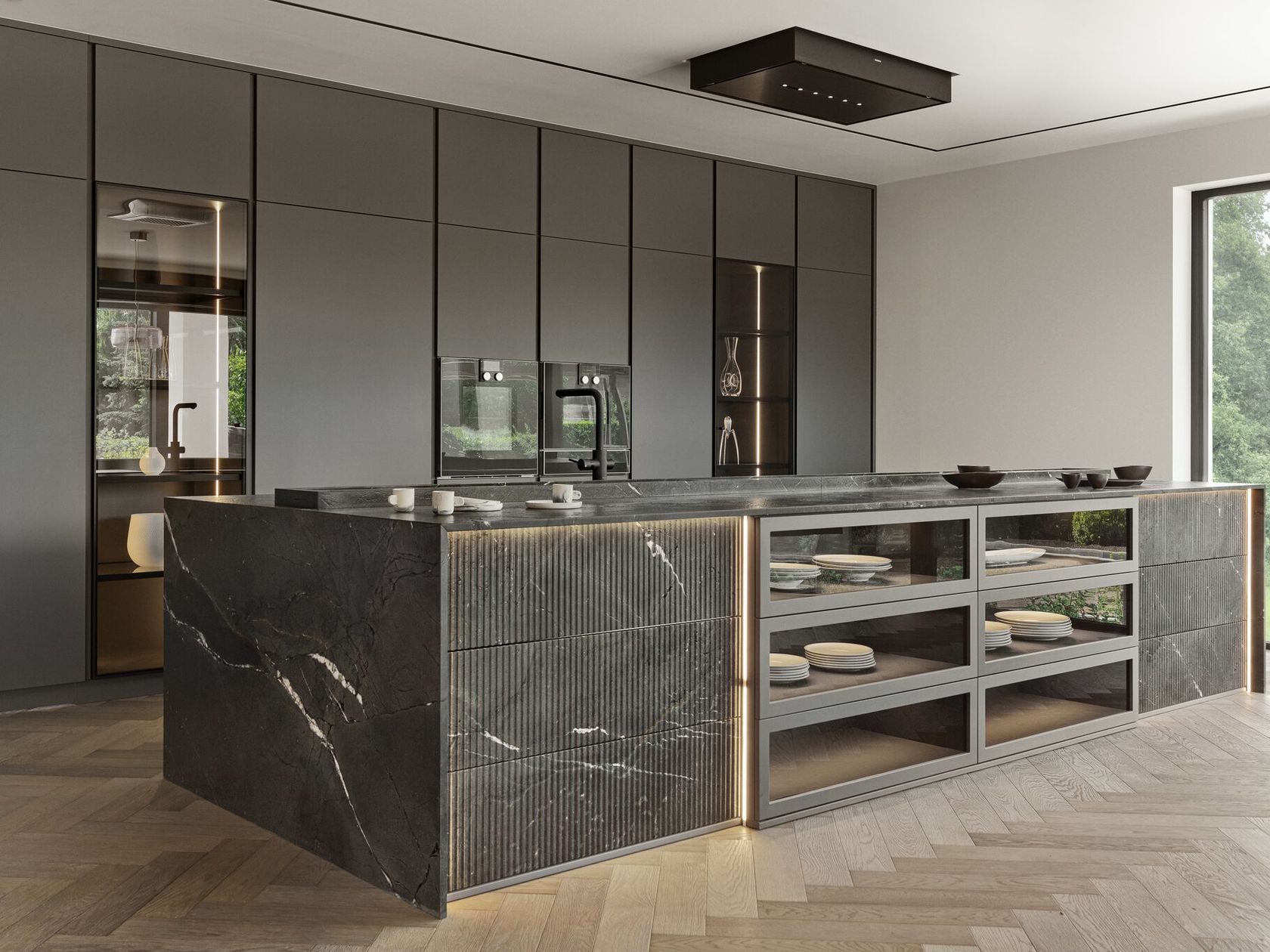 Modern kitchen with dark cabinets, large central island featuring marble countertop, open shelving, and built-in lighting. Wood herringbone flooring and view of greenery through a window.