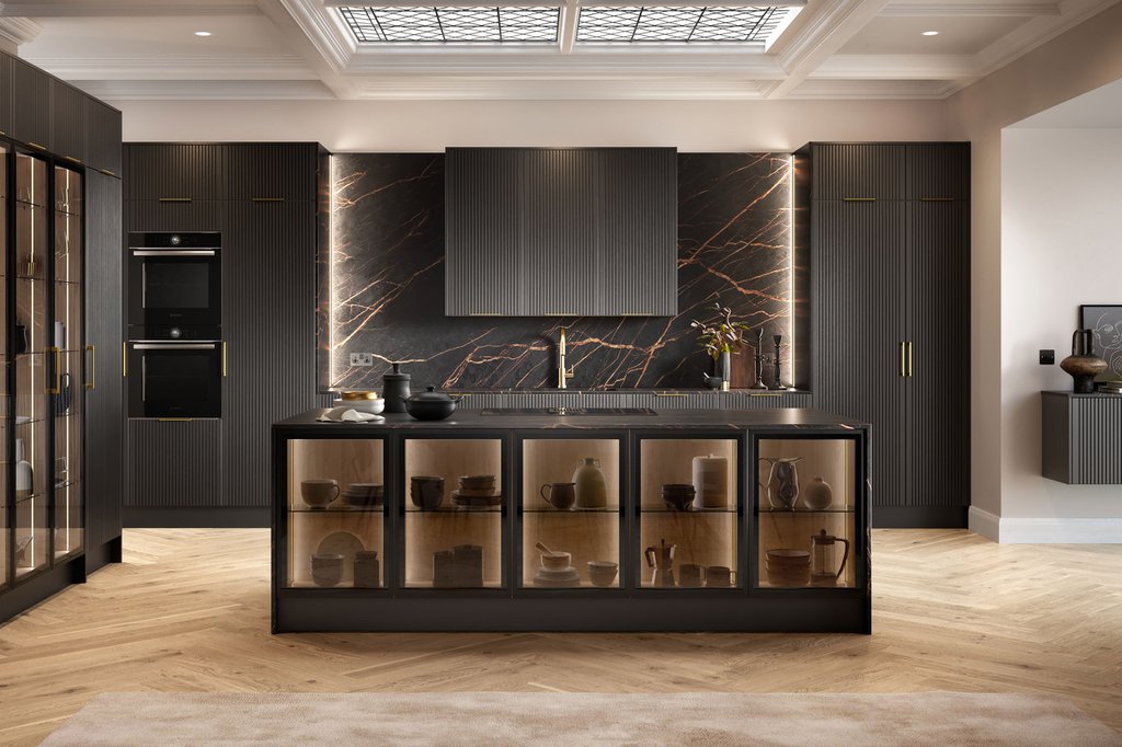 Modern kitchen with dark cabinets, a central island with glass doors, and decorative dishes. The backsplash features a dark marble design, and the room is lit by ceiling lights.